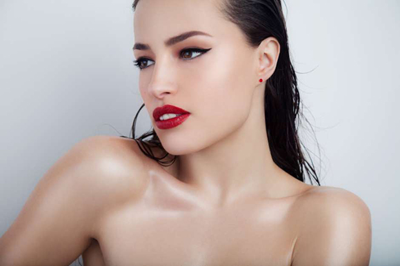 beautiful woman portrait with stylish makeup and glowing skin, studio white